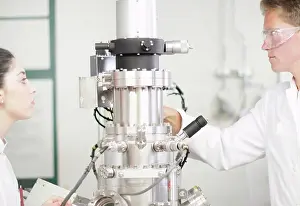 Young Adults At Work Prints: Scientists using equipment in lab