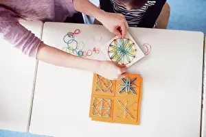Classroom Learning Tools Prints: Top view of teacher using geoboard in class