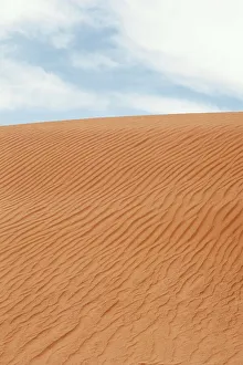Sand Dune Patterns Prints: Waves in the sand against a cloudy sky