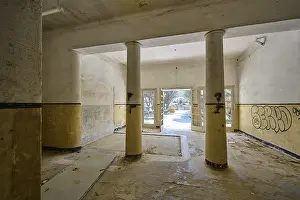 Prints of An abandoned corridor with columns, graffiti on the walls and daylight streaming in through the open doors, Lost Place, Former Santorium, Tuberculosis Centre 1947-1970 Painting Prints: Abandoned Corridor Print, Eleousa, Rhodes, Greece 1947-1970