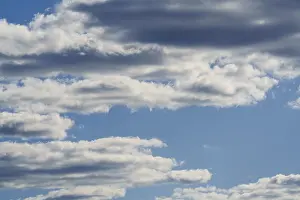 Deserted Blue Skies Prints: Abstract fluffy white clouds float in the blue sky background