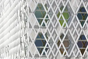 Abstract Architectural Style Prints: Abstract view of a auditorium facade showcasing geometric patterns of interlocking diamond shapes and hexagonal windows