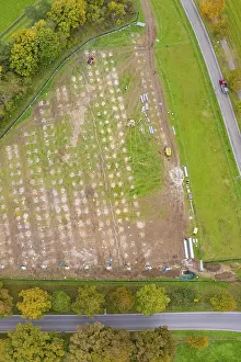German Countryside Aerial View Prints: Aerial view of a large rectangular field with construction activities surrounded by autumn trees