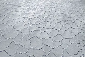 Desolate Landscape Photography Prints: Aerial view of a saline mudflat with a distinctive cracked surface pattern