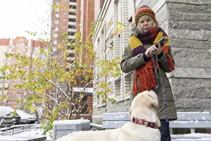 Purebred Dog Head Shot Prints: Affection Moment. Outdoor winter scene where woman shares tender moment with pet dog surrounded by snow and bare trees