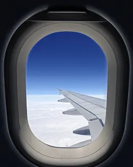 Airplane Window View Prints: Airplane window, wing of the plane and clouds