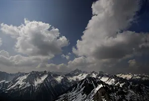 Snow Covered Mountains Europe Prints: Algaeu Alps under a cloudy sky and the peak of Mt