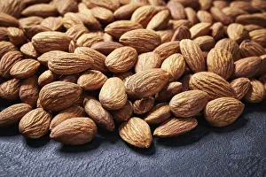 Black Background Photography Prints: Almond nuts on black table, selective focus