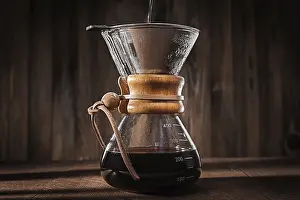 Prints of Alternative Method To Make Delicious Flavoured Coffee. Hot Water Pouring Intoo Glass Coffee Dripper. Hot Fresh Brewing Flavoured Coffee. Close Up View Arabica Prints: Hot Water Pouring into Glass Coffee Dripper Print