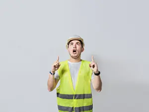 Construction Worker Pointing Prints: Amazed engineer pointing at an advertisement