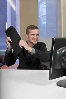 Single Person Working Hard Prints: Angry man using a desktop computer for business