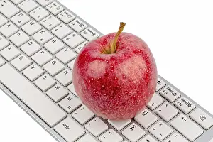 Balanced Diet Concept Prints: An apple lies on the keyboard of a computer