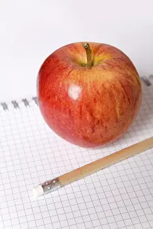 Apple Still Life Prints: Apple and a pencil on a note block