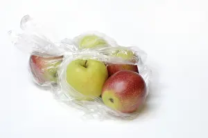 Single Colored Background Images Prints: Apple in plastic bag, packaging