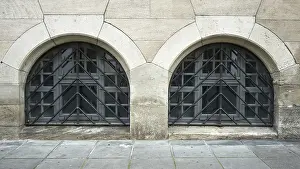 Stone Wall Architecture Prints: Two arched windows in a stone wall with symmetrical lattice elements