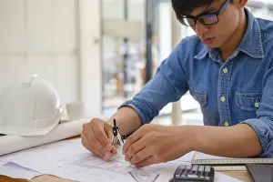 Architectural Design Prints: An architect and engineer carefully using a compass to create house plans