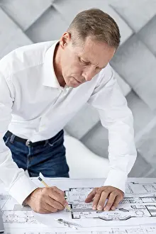 Modern Architecture Prints: Architect working complex plan