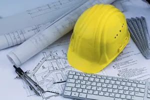 Construction Plan Prints: An architect's construction plan with a builder's helmet