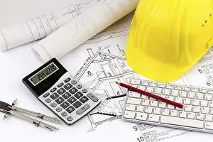 Architect Construction Plan Prints: An architect's construction plan with a builder's helmet