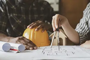 Office Architecture Design Prints: Architecture drawing something while working with blueprint in the office