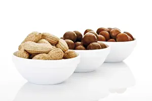 Assorted Nuts Prints: Assorted nuts in ceramic bowls