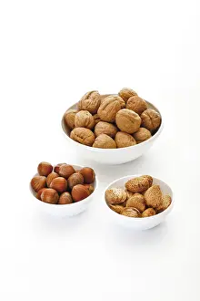 Assorted Nuts Prints: Assorted nuts in ceramic bowls
