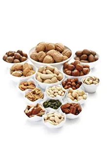 Assorted Nuts Prints: Assorted nuts and kernels in ceramic bowls