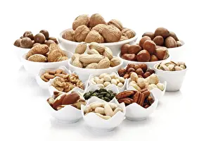 Assorted Nuts Prints: Assorted nuts and kernels in ceramic bowls