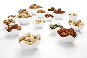 Assorted Nuts Prints: Assorted nuts and kernels in ceramic bowls