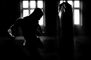 Kickboxing Athlete Prints: Athlete hits the bag. Dramatic light
