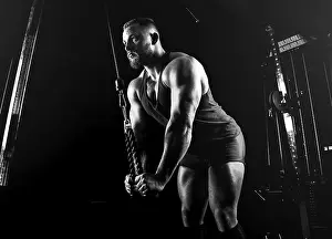 Male Athlete Training Prints: The athlete performs an exercise on the triceps on a special device