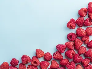 Healthy Eating Picture Prints: Background of raspberries. Raspberry on blue background with copy space