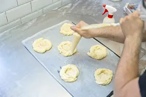 Baker Workshop Prints: Baker of bakery in the workshop workshop of artisan bakery preparing the buns before baking