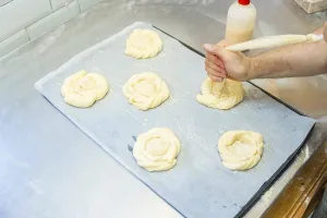 Baker Workshop Prints: Baker of bakery in the workshop workshop of artisan bakery preparing the buns before baking