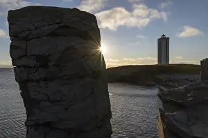 Icelandic Coastal Scenery Prints: Basalt column and lighthouse in the backlight