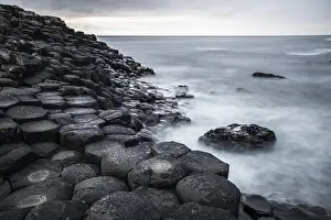 Uninhabited Irish Coastline Prints: Basaltic rocks on the shore with waves