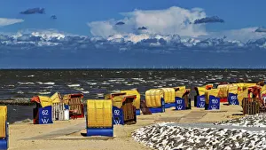 Dramatic Sky Photography Prints: Several beach chairs along a windy beach with dramatic sky in the background
