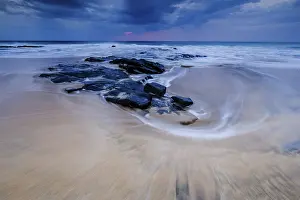 Cloudy Day At The Beach Prints: Beach with stones, waves and clouds