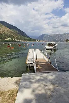 Prints of Very beautiful promenade of the Bay of Kotor, a small fishing boat. Montenegro. Beautiful and cozy city, Kotor embankment. The concept of rest and vacation in Europe Montenegro Prints: Beautiful Kotor Promenade Print, Montenegro