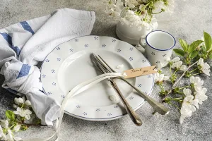 Elegant Table Setting Prints: A beautifully arranged table setting features a white plate with blue patterns