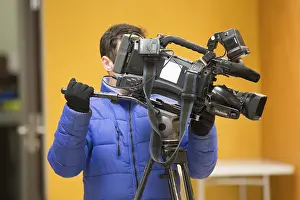 Prints of Belarus, Gomel, on March 29, 2018. Community Center. Days of Russian Culture in Belarus.Male cameraman in a television studio. Video Operator Related Image Prints: Print of Belarus, Gomel: Days of Russian Culture