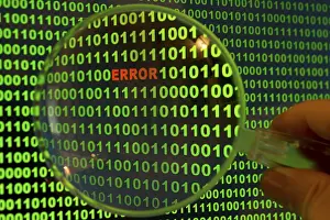 Data Security Breach Prints: Binary code with the word 'Error' viewed through a magnifying glass Binary code with the word