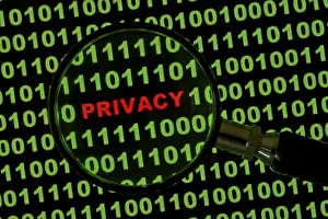 Electronic Data Protection Prints: Binary code with the word 'Privacy' viewed through a magnifying glass Binary code with the word