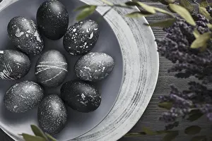Christian Holiday Traditions Prints: Black painted eggs for Easter on a blue plate