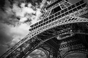 Black And White Travel Photography Prints: A black and white view of the Eiffel Tower with dramatic clouds overhead in Paris