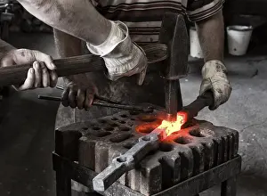 Workplace Safety Prints: Blacksmith and his assistant at work