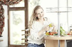 Vegetable Starter Dishes Prints: Blond lady at kitchen preparing vegetable for breakfast