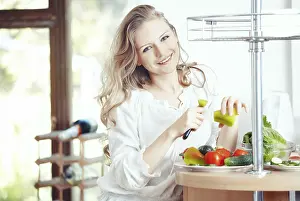 Healthy Lunch Options Prints: Blond lady at kitchen preparing vegetable for breakfast