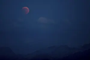 Natural Phenomenon Photography Prints: Bloodmoon, total lunar eclipse over mountain range