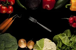 Nutrition Food Image Prints: Border made of different vegetables with fork in the middle on black background